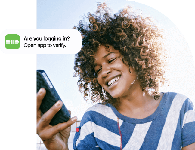 Woman looking at mobile phone message from Duo asking if she's logging in.
