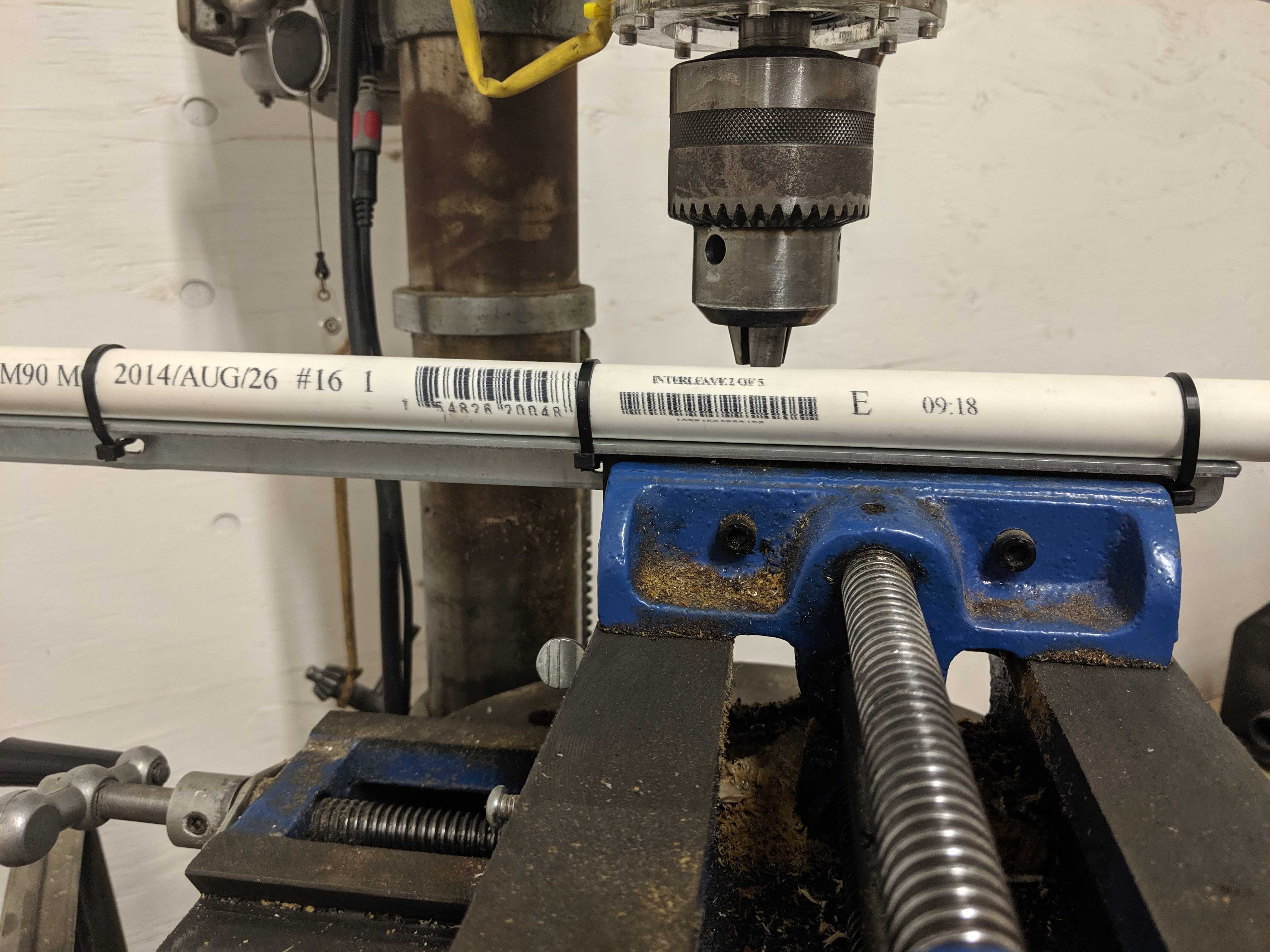 Photo showing a drill press and a PVC pipe